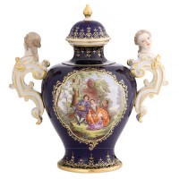 Covered vase with “Watteau painting” and volute handles surmounted by female heads